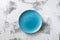 Blue Plate on white scraped wooden background