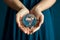 Blue pledge Female hands embrace a globe, symbolizing Earth conservation
