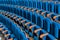 Blue plush chairs with wooden armrests in the auditorium. Empty auditorium in the theater