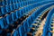 Blue plush chairs with wooden armrests in the auditorium. Empty auditorium in the theater