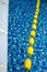 Blue pool water and yellow swimming lane marker in swimming pool