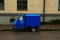 Blue postal truck parked on the street