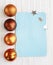 Blue postcard on the background of white texture of woolen fabric with pigtail pattern and orange Christmas toys balls