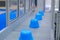 Blue pots on conveyor belt of plastic injection molding machine