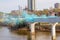 The blue powder station on a bridge over the Arkansas River at a color holi festival in Tulsa USA with people running through in