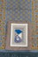blue prayer beads and white islamic book holy quran on blue praying mat