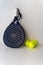 blue professional paddle tennis racket with yellow balls on white background