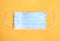 Blue protective medecine mask on yellow background,coronavirus protection