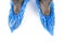 Blue protective shoe covers on female shoes  on white background