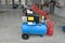 Blue pump compressor for washing cars, indoor. Cleaning concept.