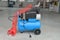 Blue pump compressor for washing cars, indoor. Cleaning concept.