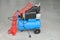 Blue pump compressor for washing cars, indoor. Cleaning concept.