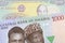 A blue, purple and green one thousand  naira note from Nigeria paired with a yellow one thousand dong bill from Vietnam.