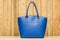 Blue purse on wood background