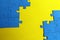 Blue puzzles scattered on a yellow background