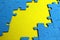 Blue puzzles scattered on a yellow background