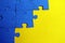 Blue puzzles scattered on a yellow background