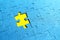 Blue puzzles scattered on a yellow background