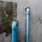 Blue PVC pipe water flow device for garden and drinking use.