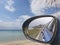 Blue rearview mirror and the beach