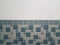 Blue rectangle and square tiles on bathroom wall