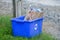 Blue recycling bin filled with paper