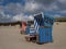 Blue and red beach chairs on the Island Langeoog with a beautiful cloudscape in the background