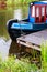 Blue and red canal boat moored in the Forth & Clyde Canal, Scotland