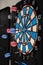 Blue and red darts on a dartboard. Picture of recreational game