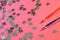 Blue and red fountain pens lie next to silver stars on a pink background. The system of performance and grades in school. Ratings