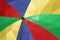 Blue red green large canvas umbrella in daylight sunshine low polygon background
