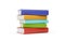 Blue, red, green and yellow hardcover books with blank covers stacked over white background