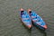 Blue red timber rowing boats on Fewa lake, Pokhara.