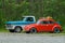 Blue and red veteran cars in the parking space