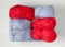 Blue and red yarn in a plastic basket. Knitting - women `s needlework