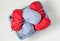 Blue and red yarn in a plastic basket. Knitting - women `s needlework