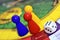 Blue, red, yellow play figures and dice on the board game