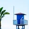 Blue rescue hut on a sandy beach, safe relax by the ocean, a beautiful sunny day