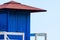 Blue rescue hut on a sandy beach, safe relax by the ocean, a beautiful sunny day