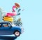 Blue retro car with luggage and summer accessories on blue background with copy space.