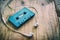 Blue retro cassette tape and white earphone on wooden table