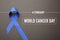 Blue ribbon on background, top view. World Cancer Day