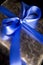 Blue Ribbon Tied in a Bow on Silver Gift.