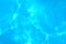 Blue ripped water in swimming pool . texture pool . Shining blue water ripple background