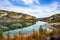 Blue river between two shores. Grey and yellow beautiful mountain cliff in a natural park congost de Mont-rebei Monrebey in Spain