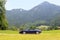 Blue roadster Porsche Boxster 986 with Bavarian Alps panorama at German Alpine Road