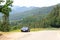 Blue roadster Porsche Boxster 986 with Bavarian Alps panorama at German Alpine Road.