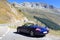 Blue roadster Porsche Boxster 986 with mountain panorama at Furka Pass road