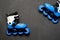 Blue roller skates on dark chalk board background