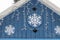 The blue roof of the house of Santa Claus in outdoor park, decorated with snowflakes and luminous bulbs